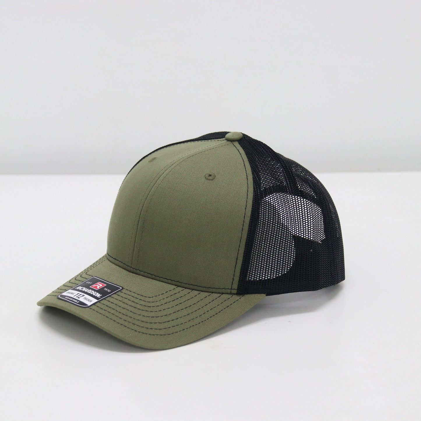 Green and black cap with mesh back on a white background