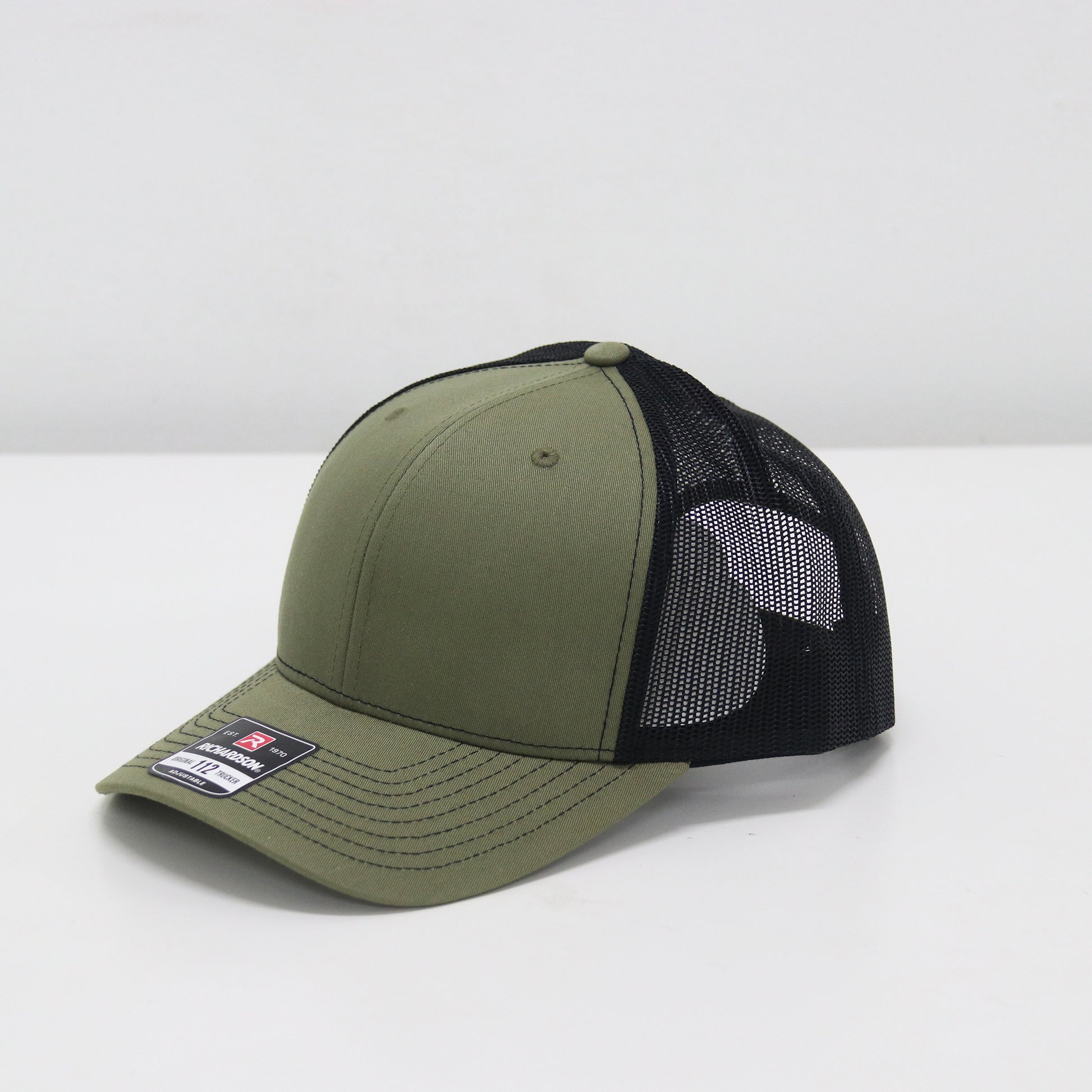 Green and black cap with mesh back on a white background