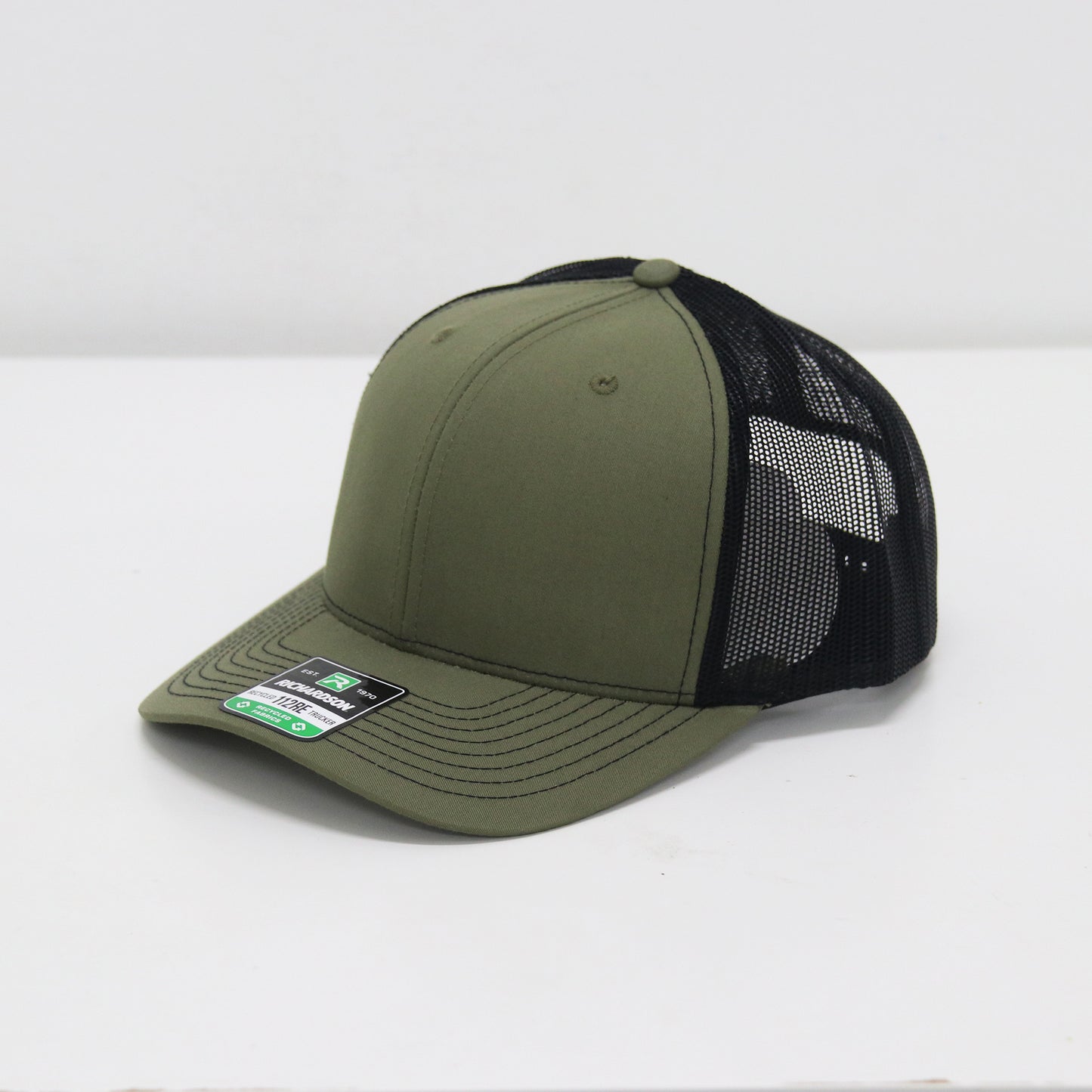 Green and black baseball cap on a white background