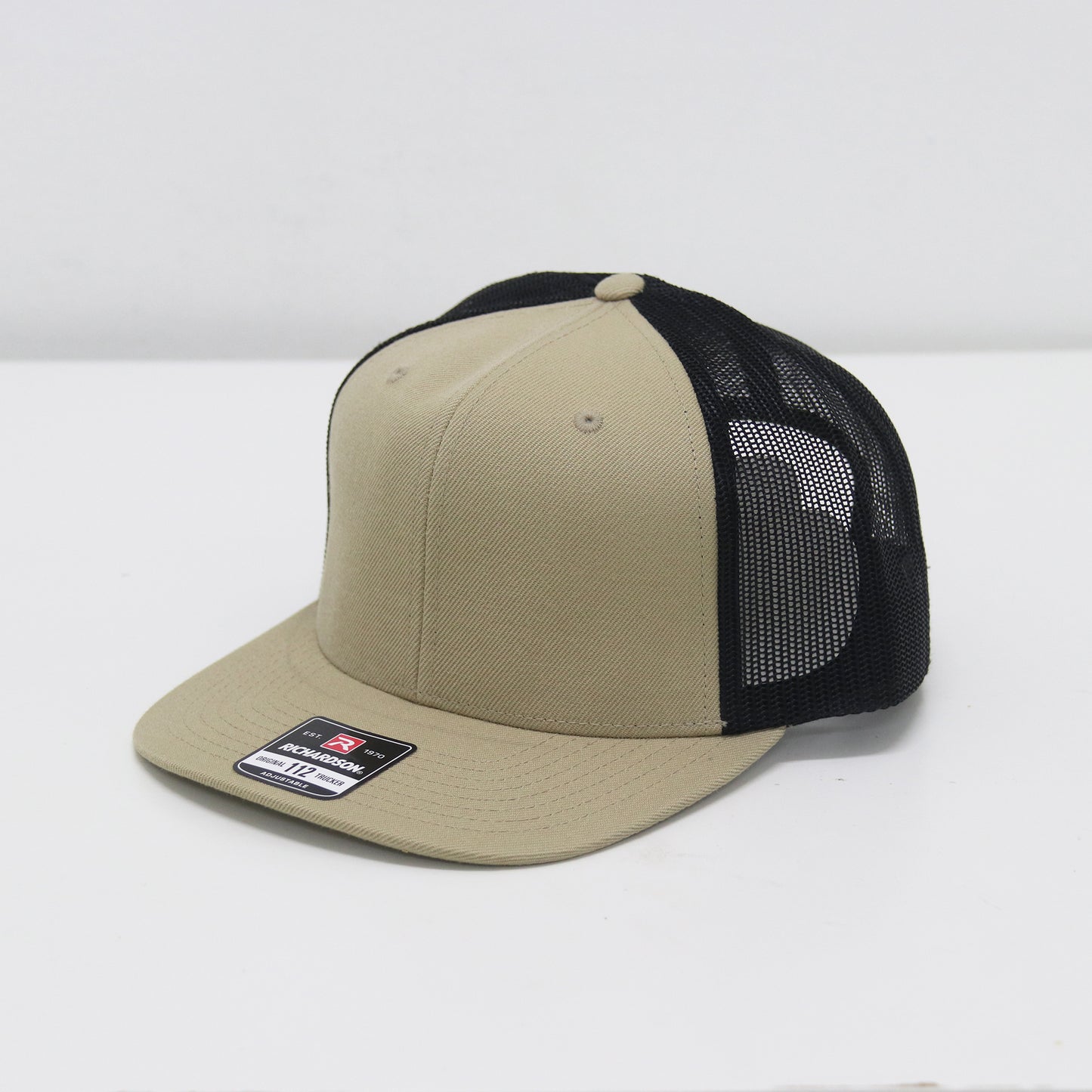 Beige and black cap with mesh back on a white background