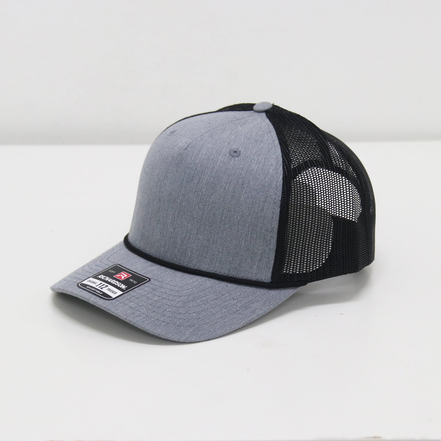 Gray and black trucker cap on a white background