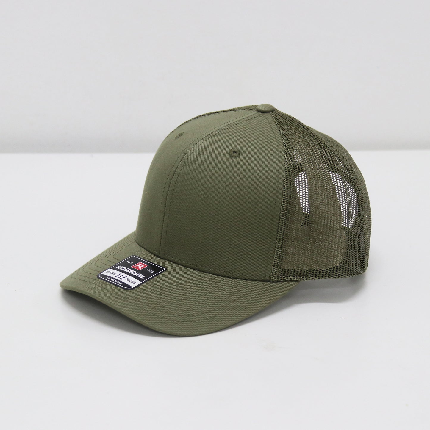Green baseball cap with mesh back on a white background