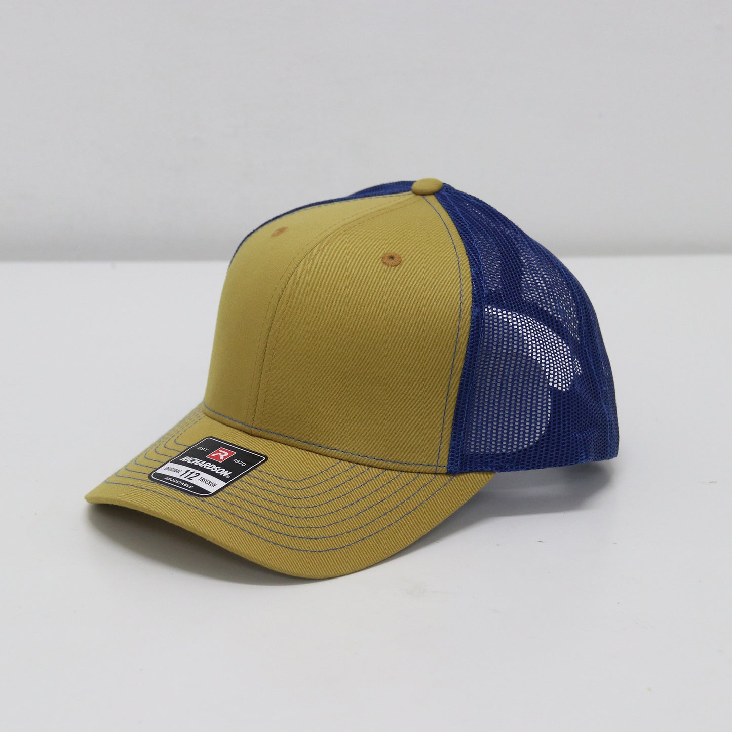 Yellow and blue cap with mesh back on a white background