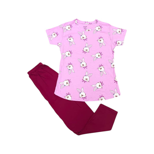 Pink pajama top with bunny print and red pants on a white background