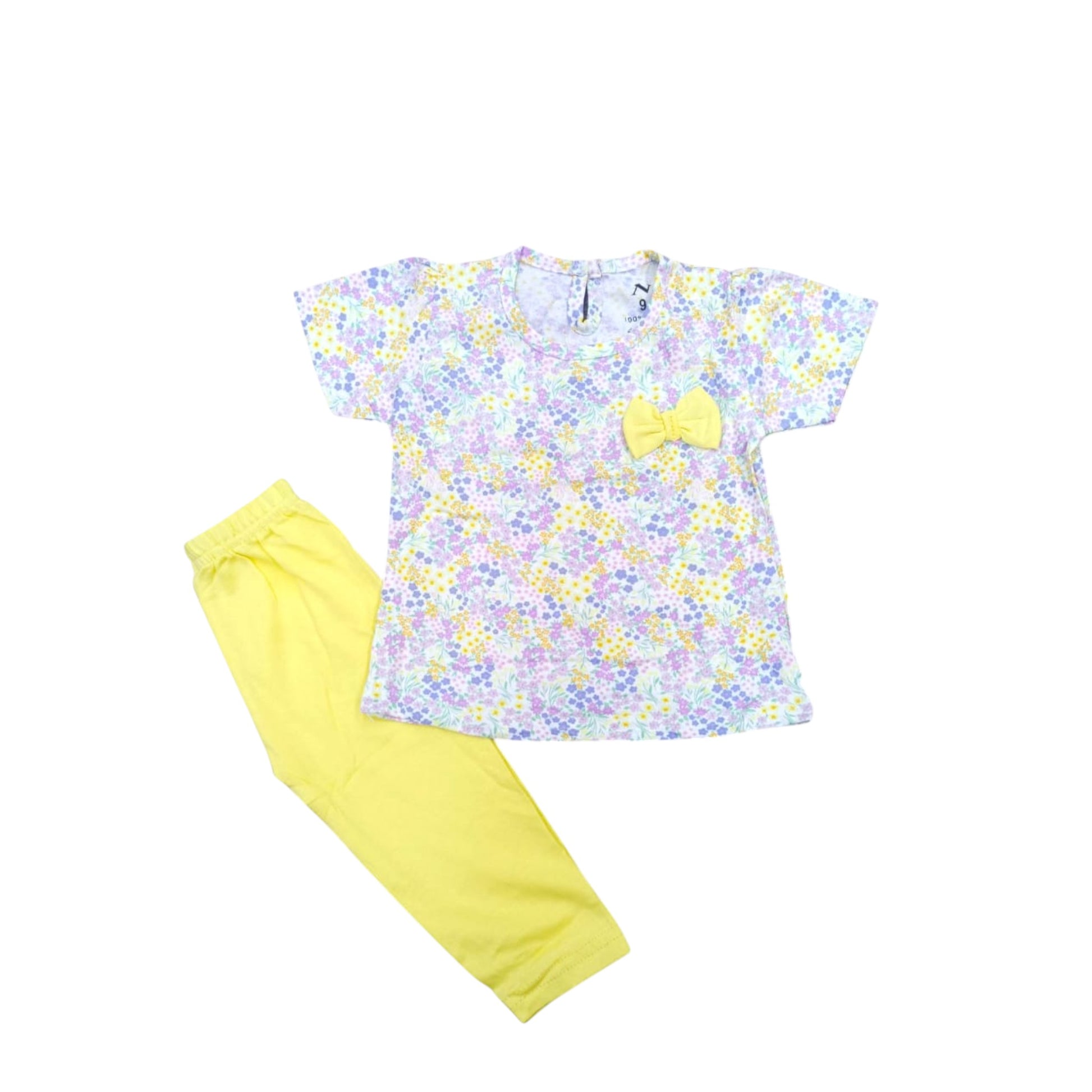 Children's outfit with floral top and yellow pants on a white background
