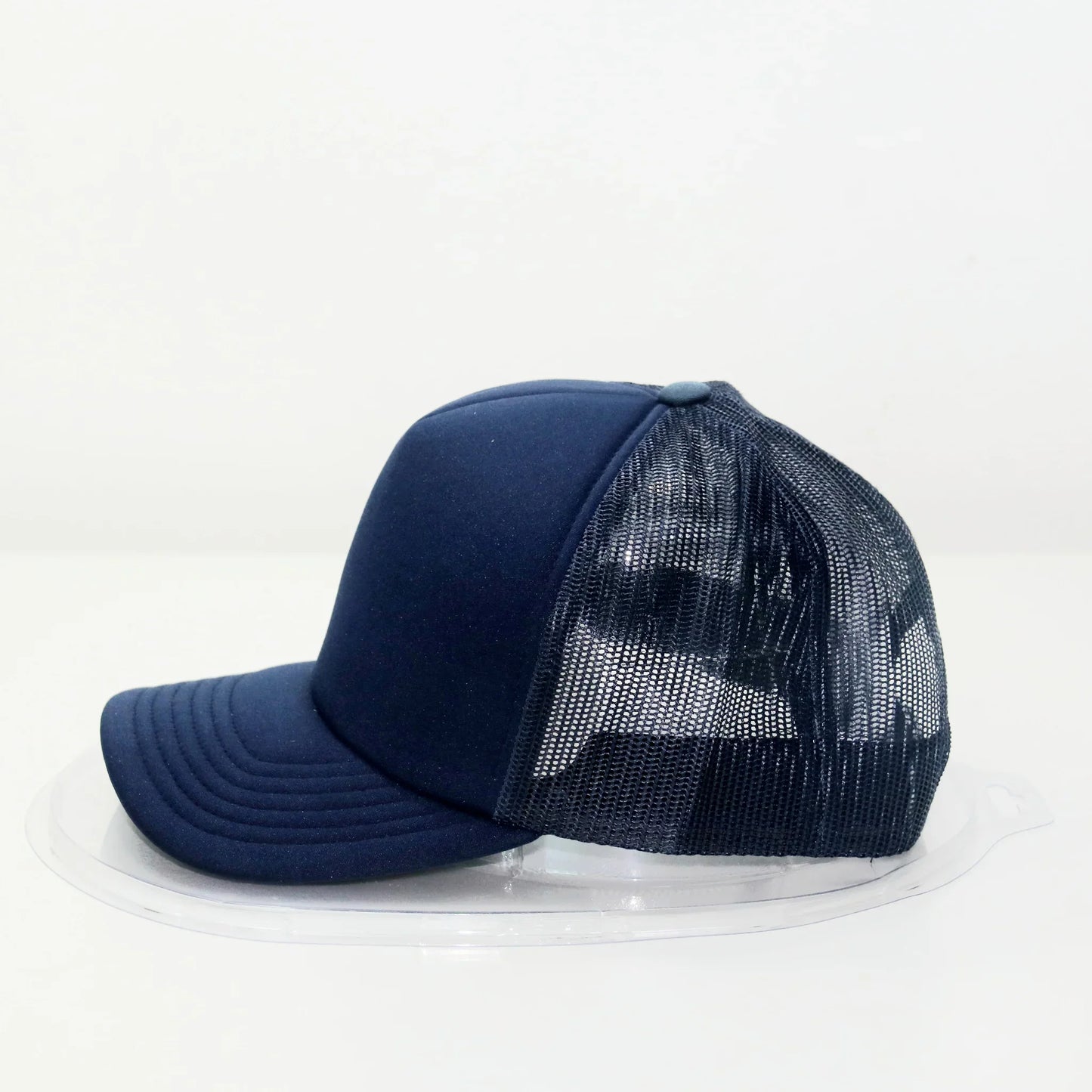 A navy blue trucker cap with a curved brim and a mesh back.