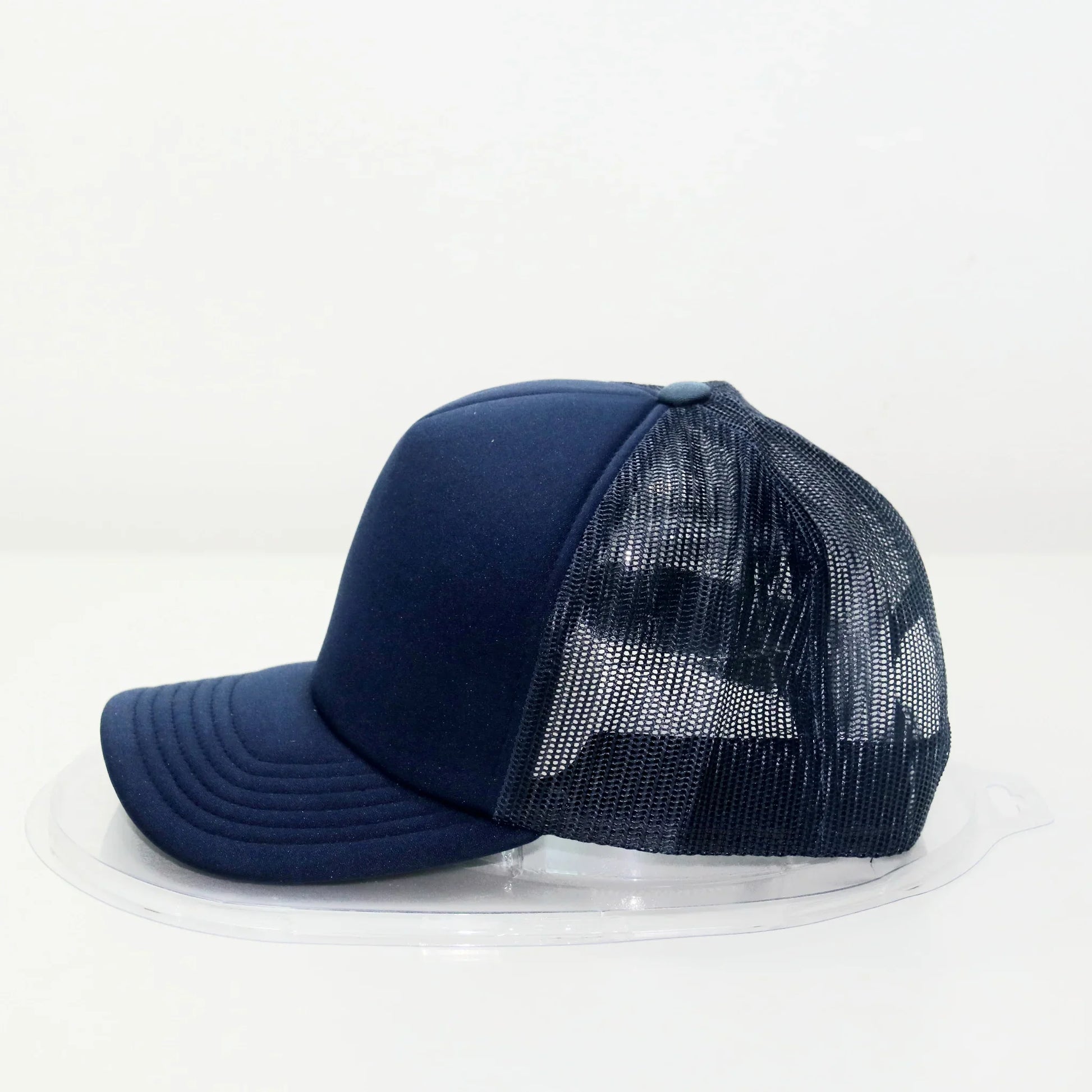 A navy blue trucker cap with a curved brim and a mesh back.