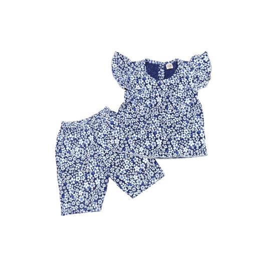 Nursery outfit with floral pattern on a white background