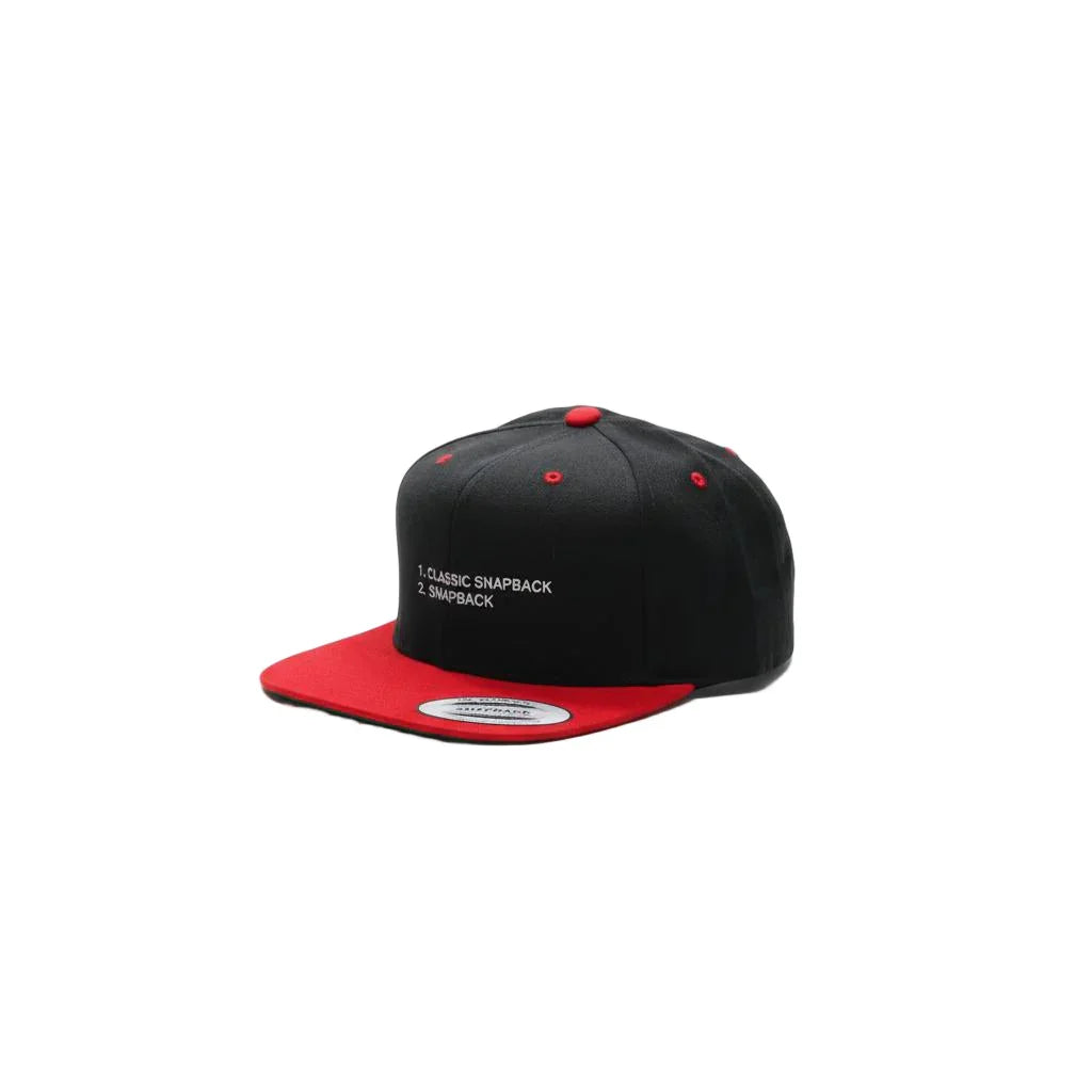 Black and red snapback cap on a white background