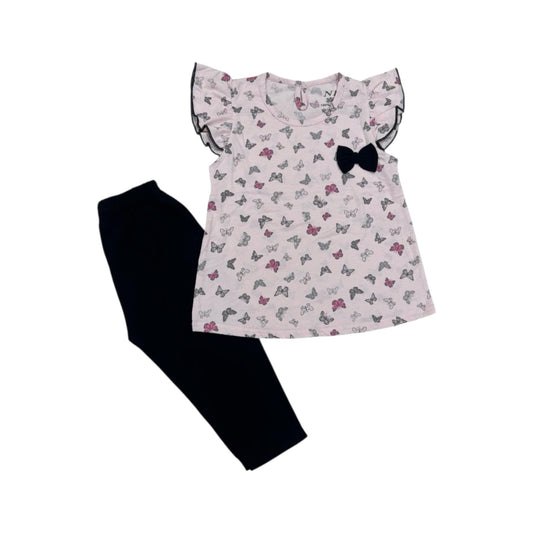 Children's outfit with a floral top and black pants on a white background