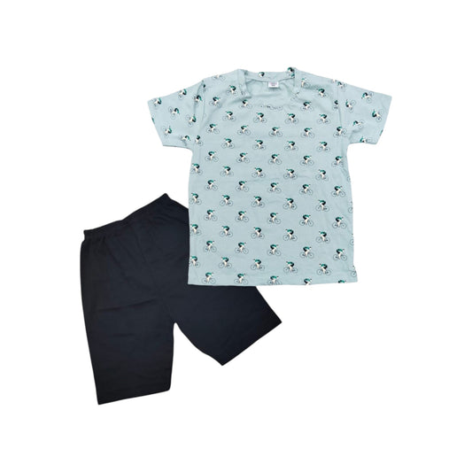 Children's outfit with a patterned shirt and black shorts on a white background