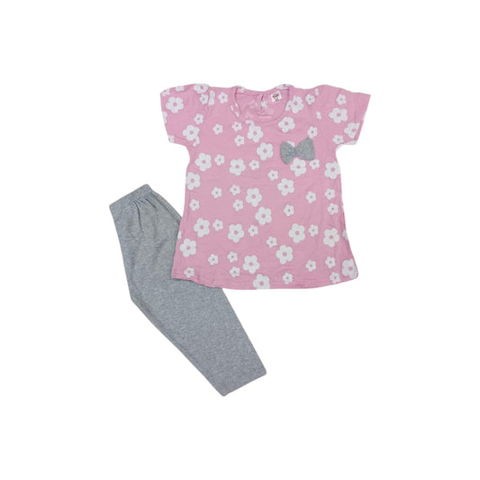 Pink floral top with a gray bow and gray pants on a white background