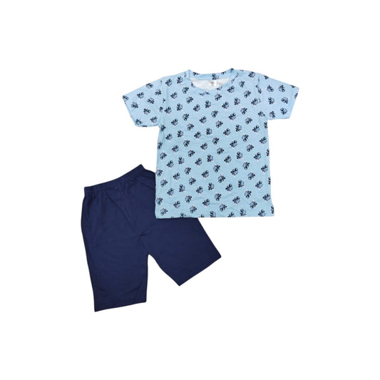 Children's blue t-shirt with black paw prints and navy shorts on a white background