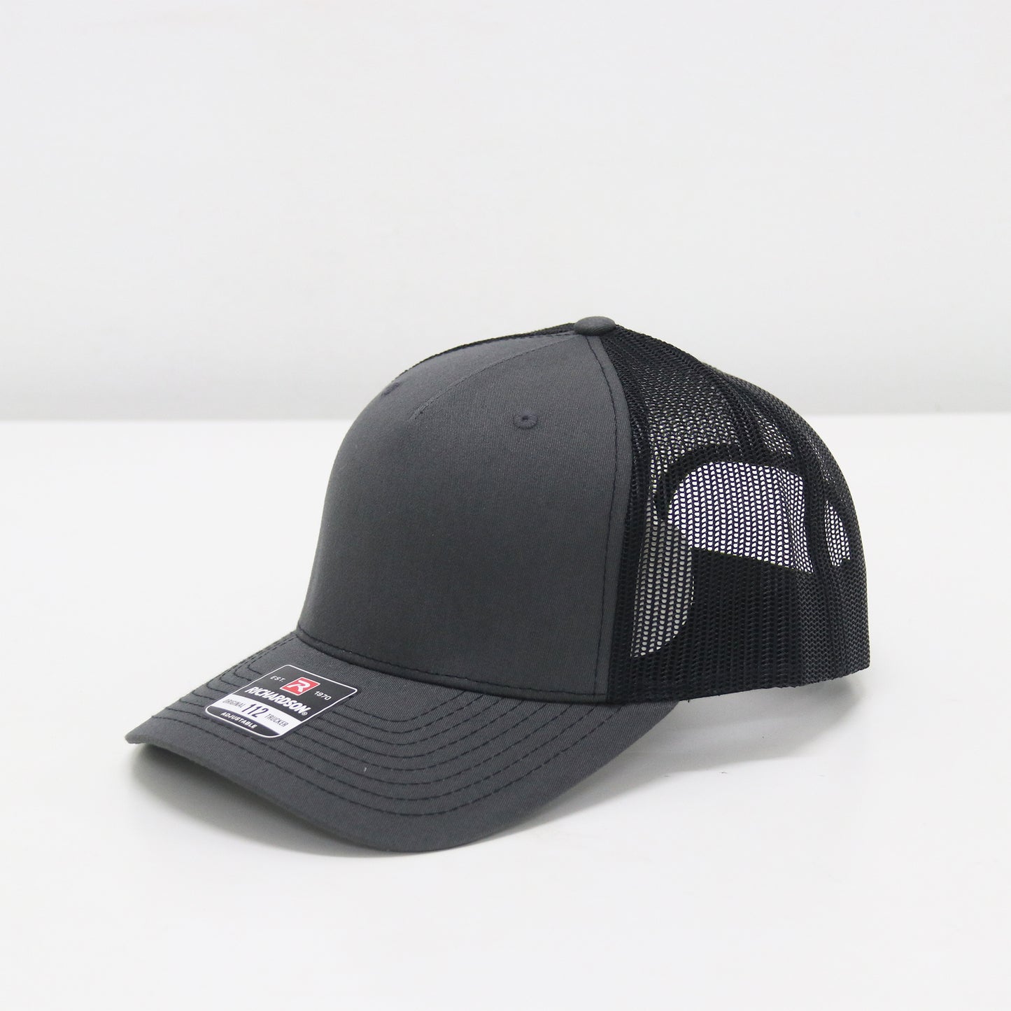 Black and gray cap with mesh back on a white background
