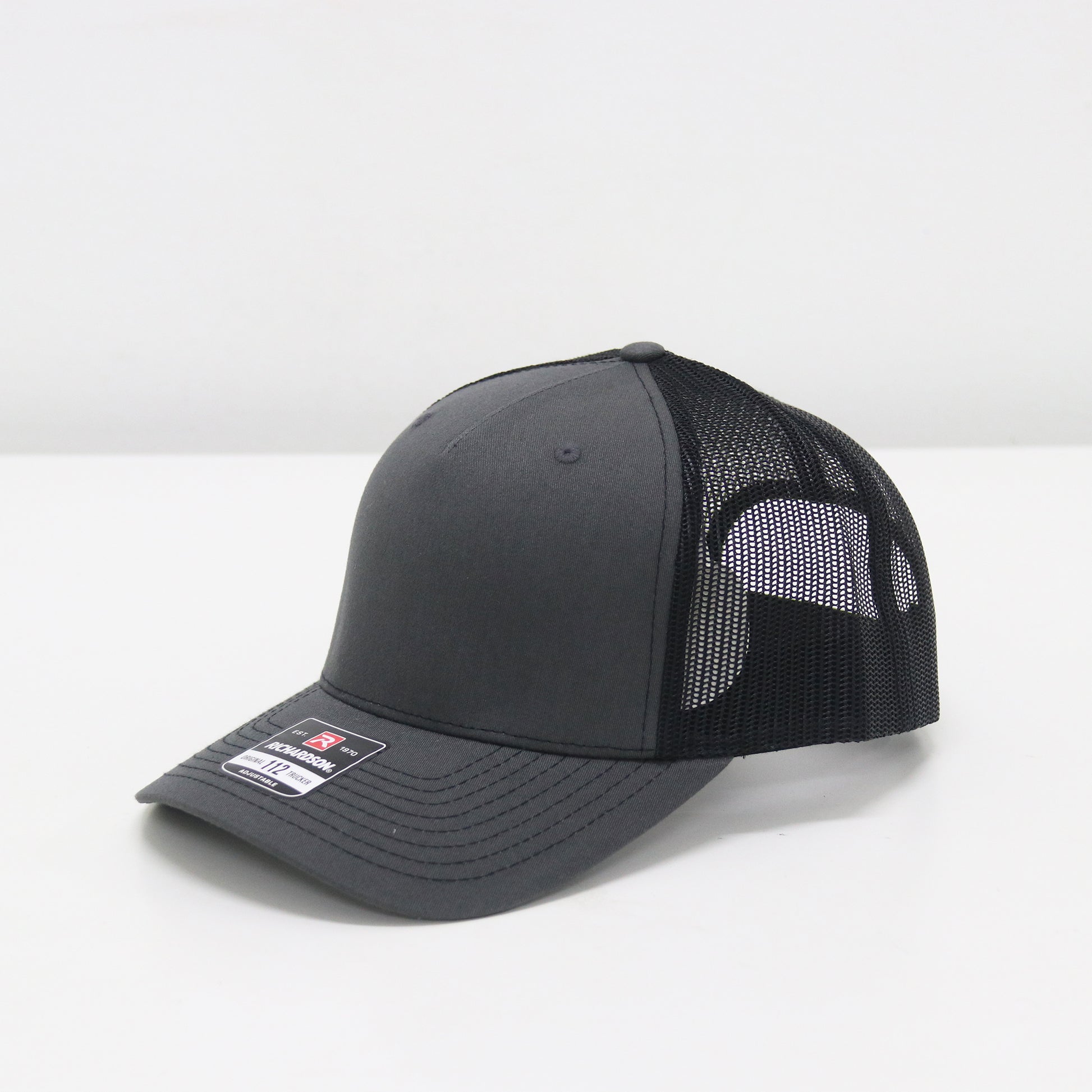 Black and gray cap with mesh back on a white background