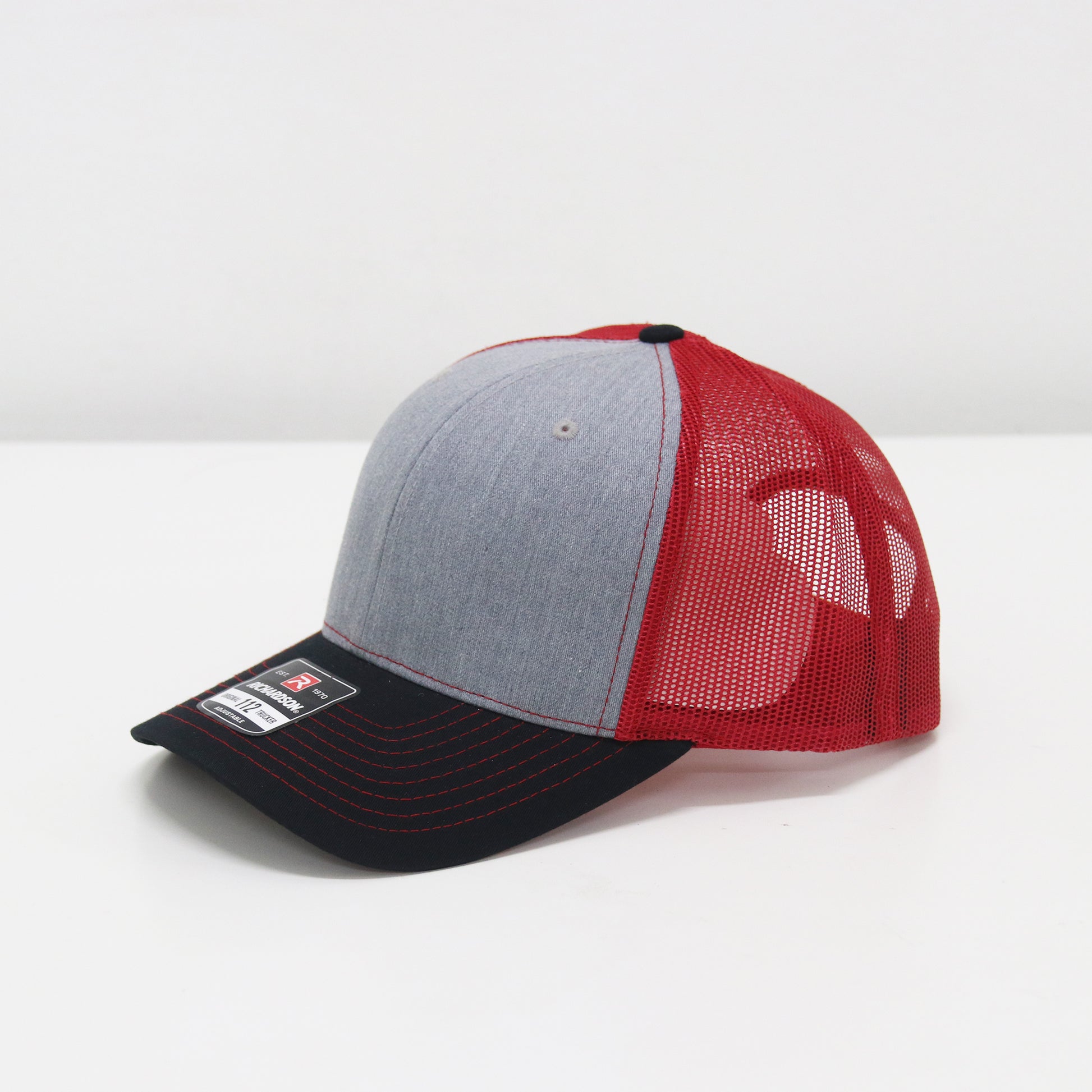 Gray, red, and black cap on a white background
