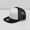 Black and white cap with mesh back on a white background