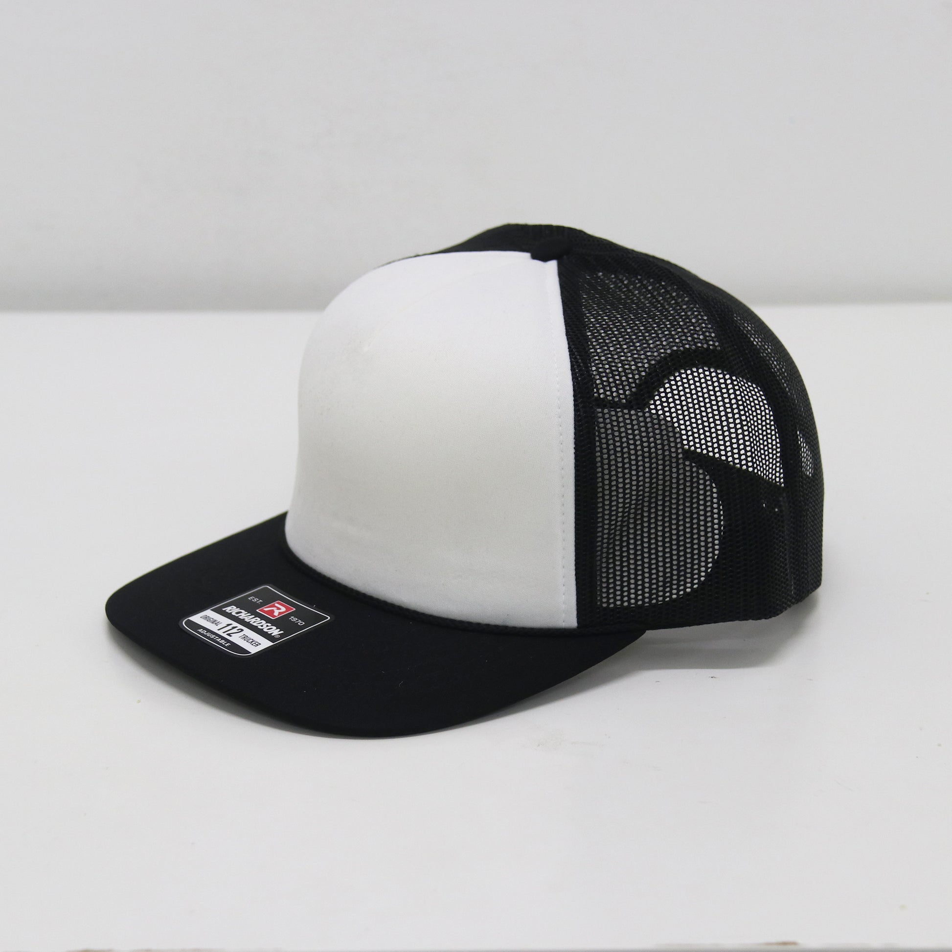 Black and white cap with mesh back on a white background