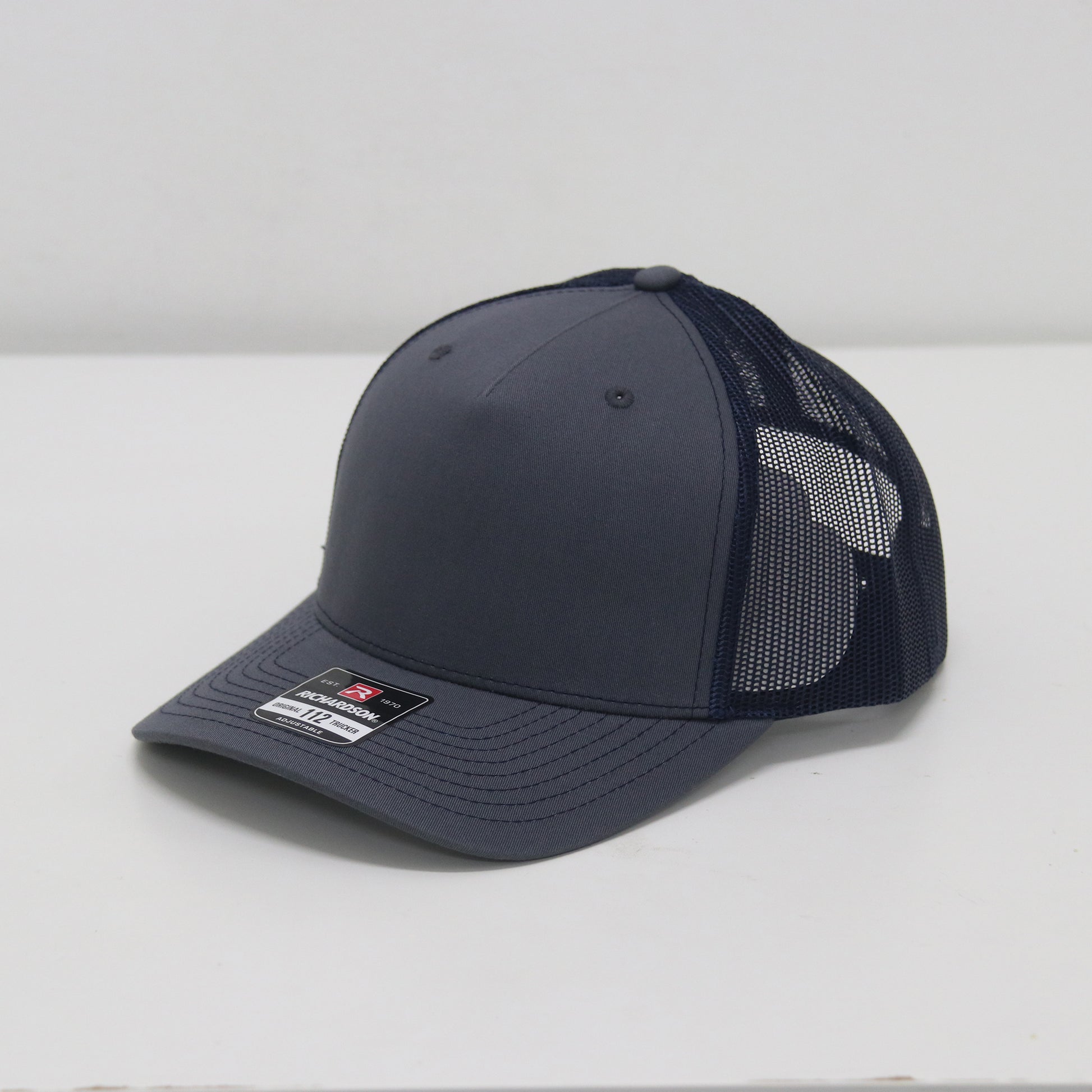 Navy blue baseball cap with mesh back on a white background