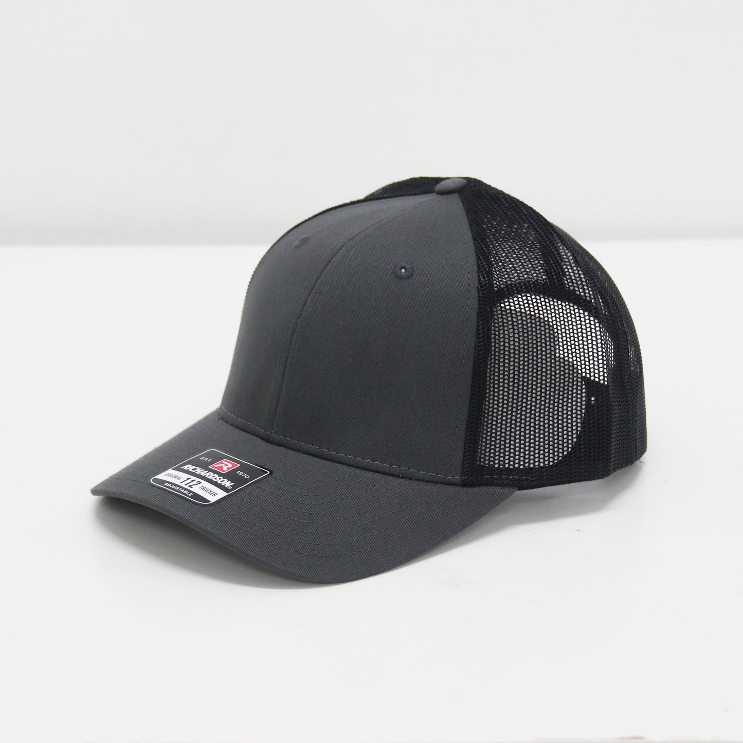 Gray and black cap with mesh back on a white background