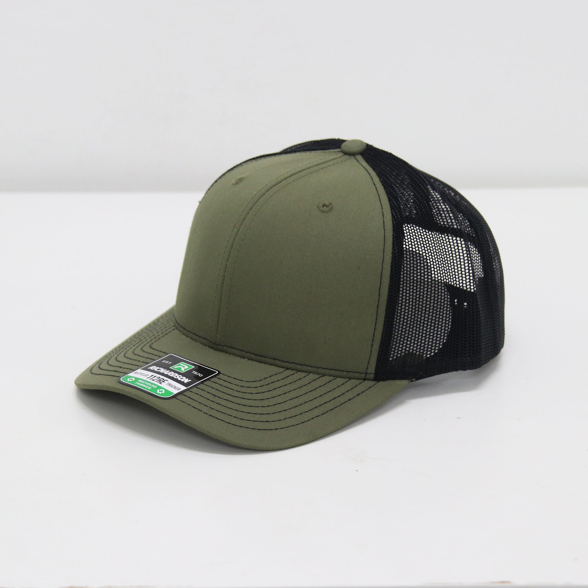 Green and black baseball cap on a white background