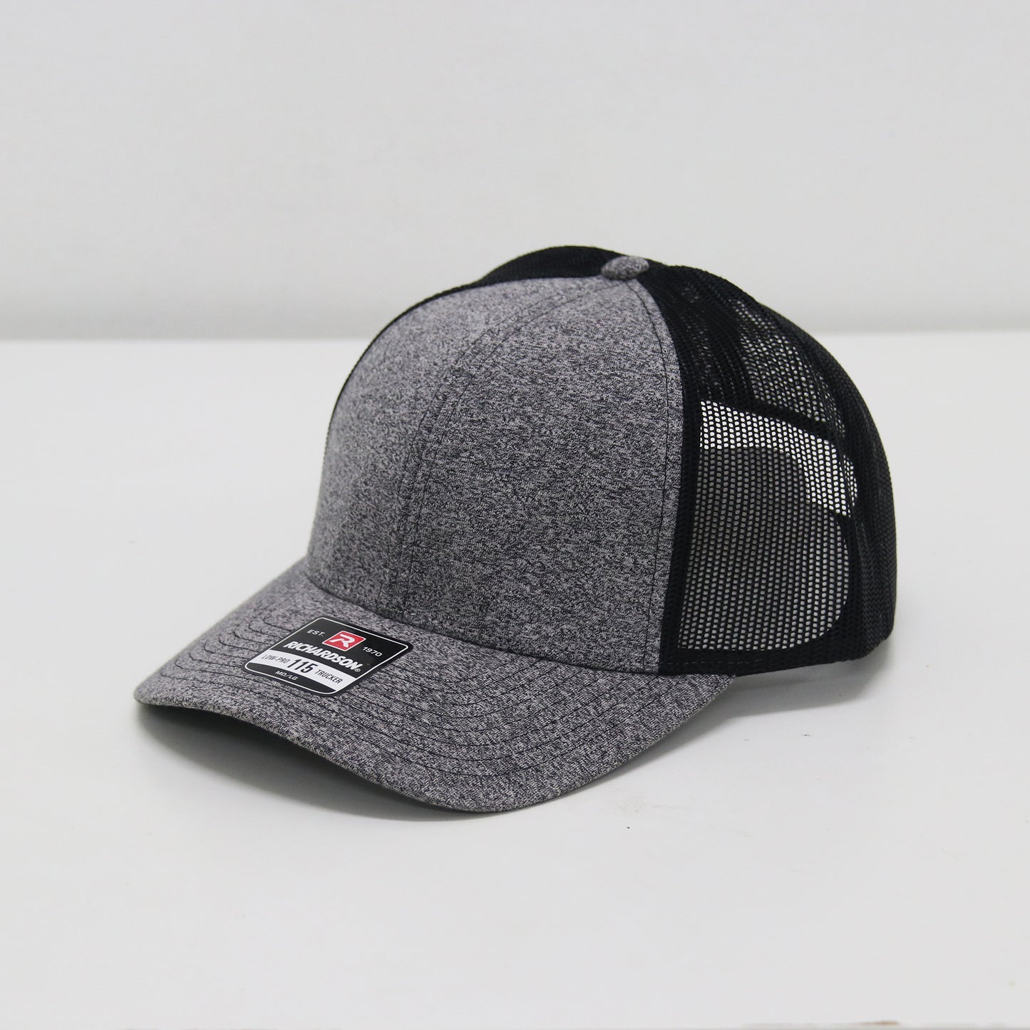 Gray and black cap with mesh back on a white background