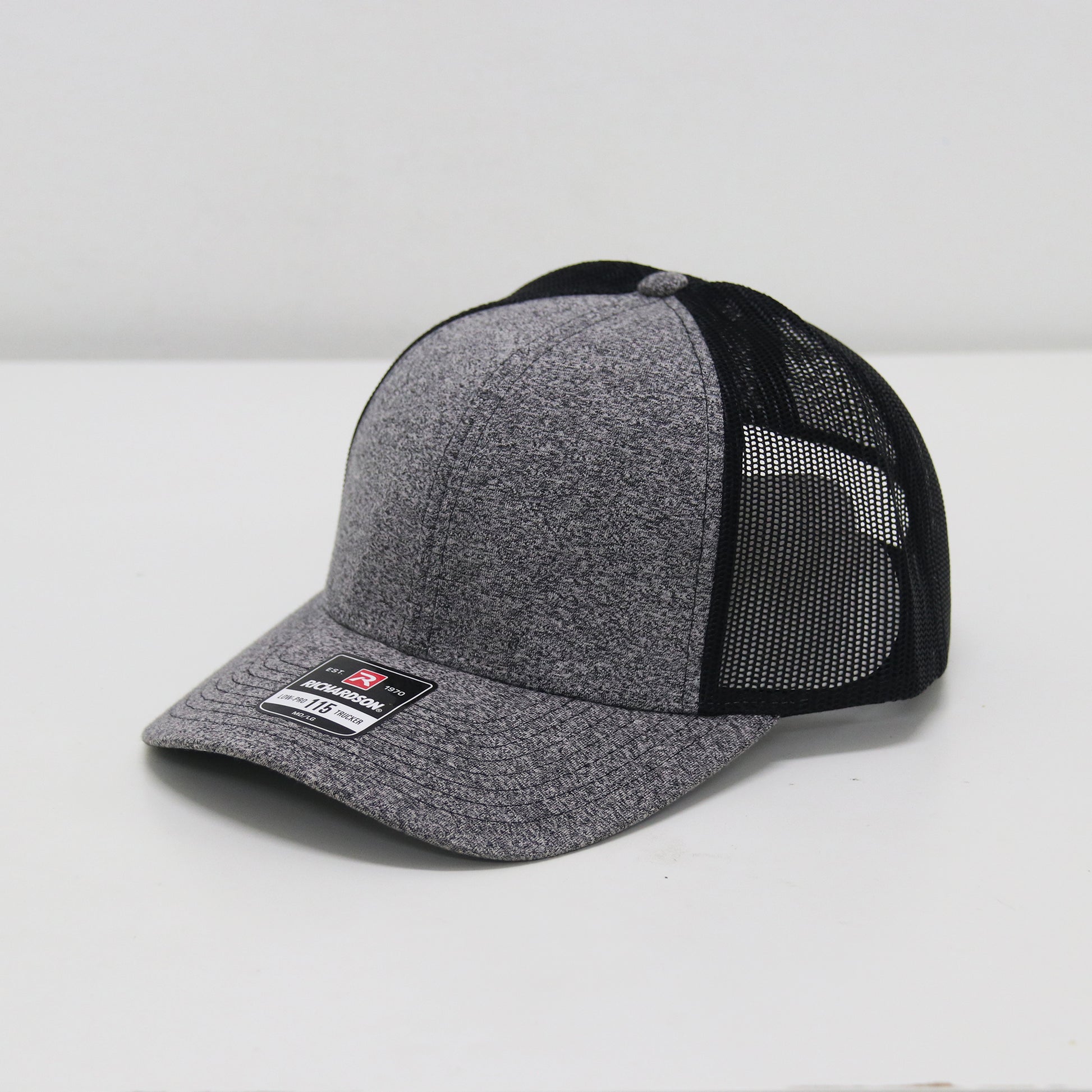 Gray and black cap with mesh back on a white background