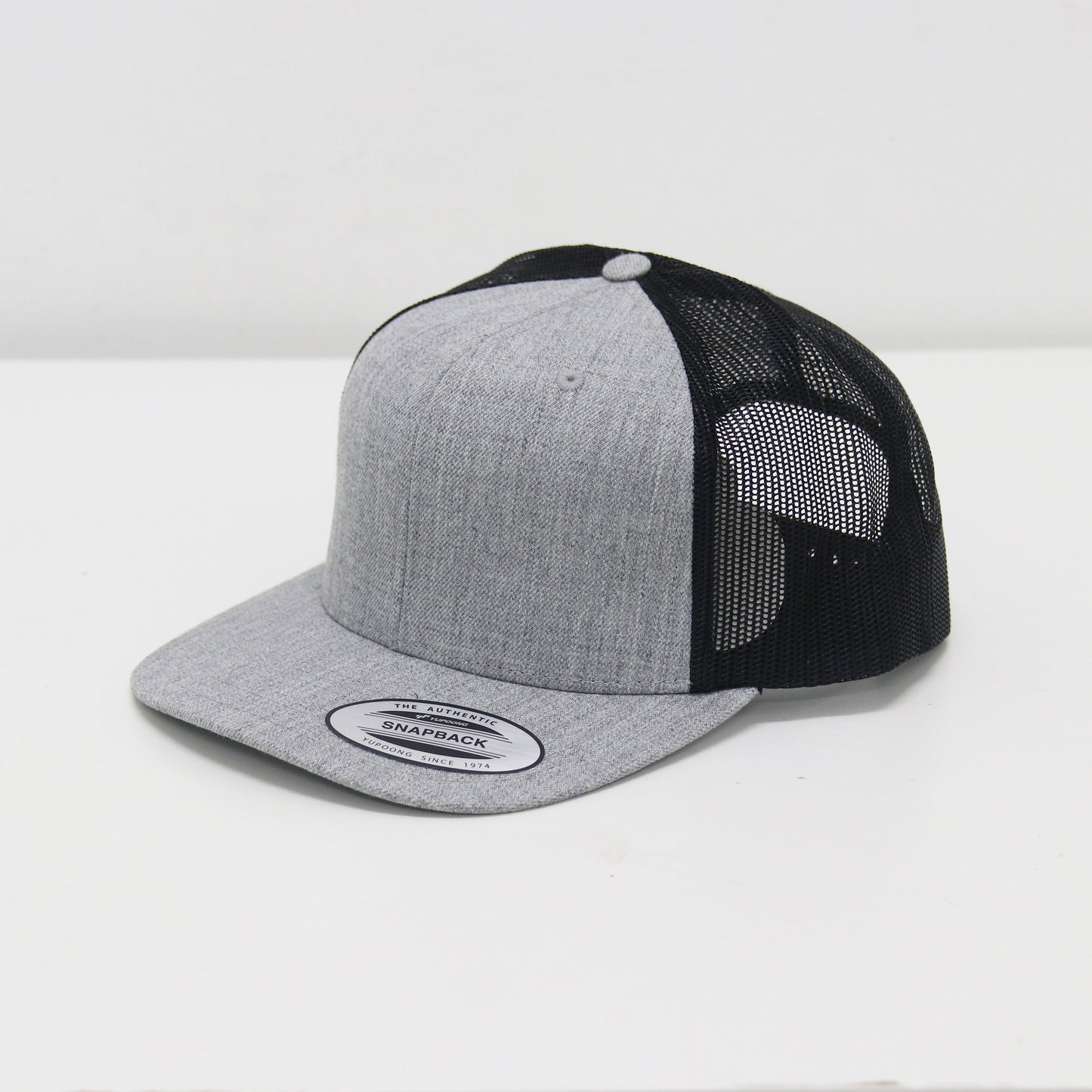 Gray and black trucker cap on a white background