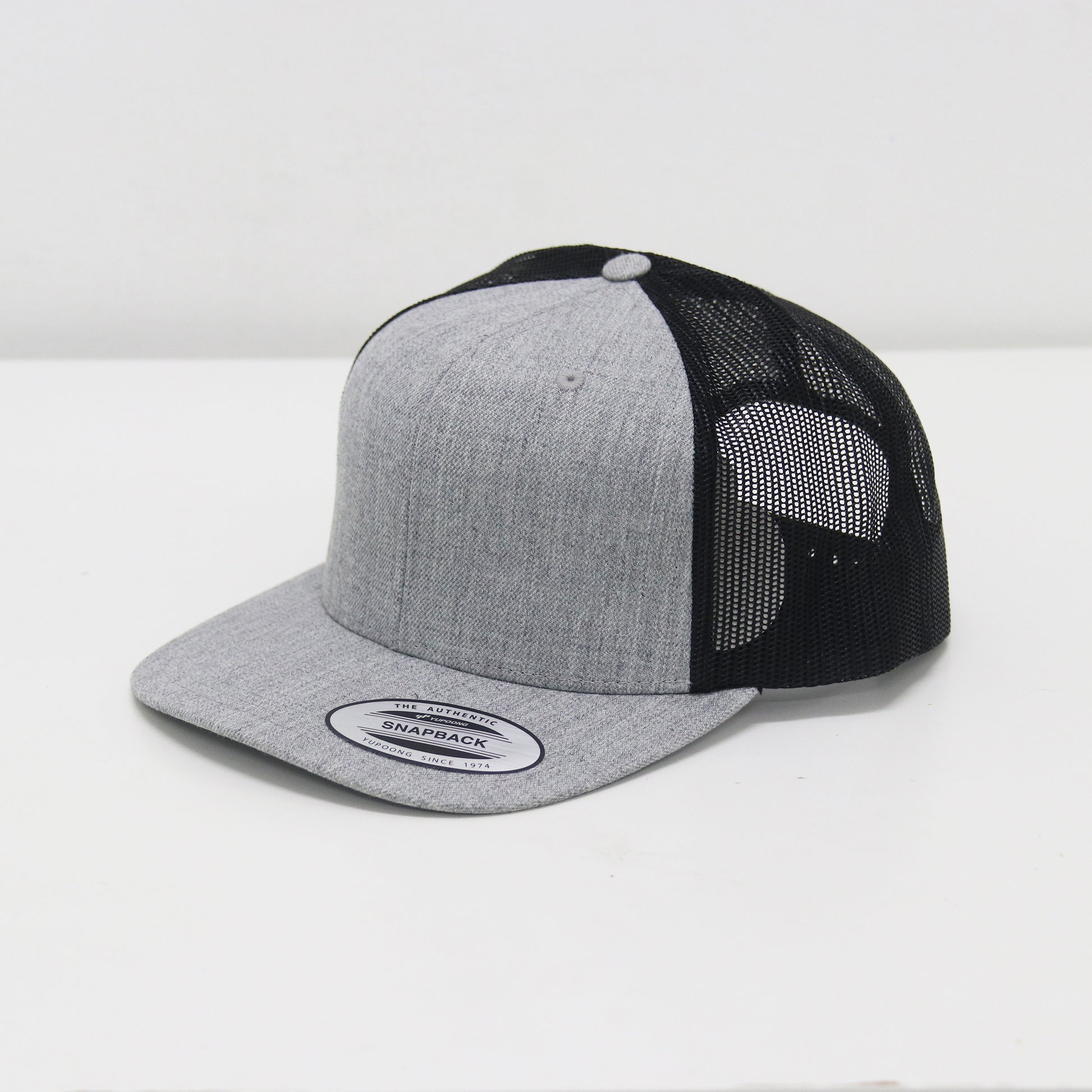 Gray and black trucker cap on a white background