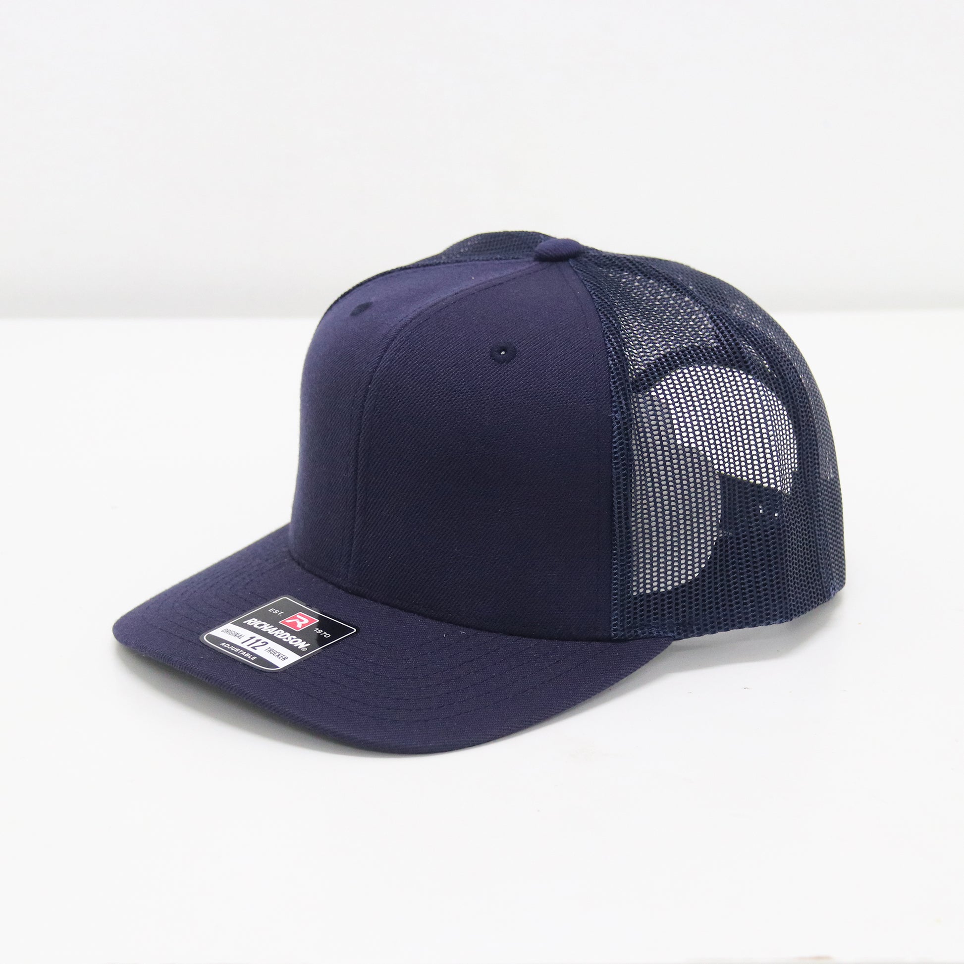 Navy blue cap with mesh back on a white background