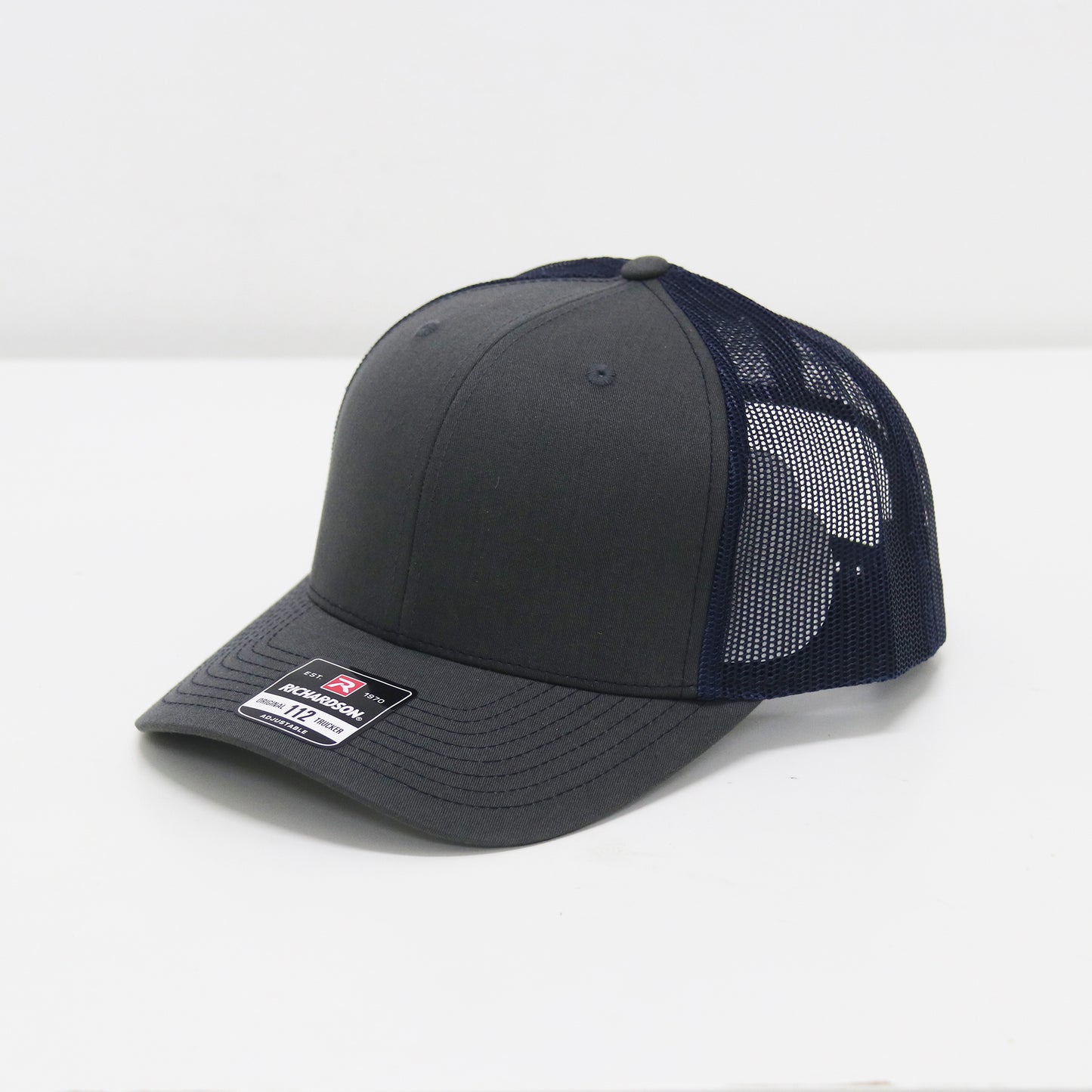 Gray and navy baseball cap with mesh back on a white background