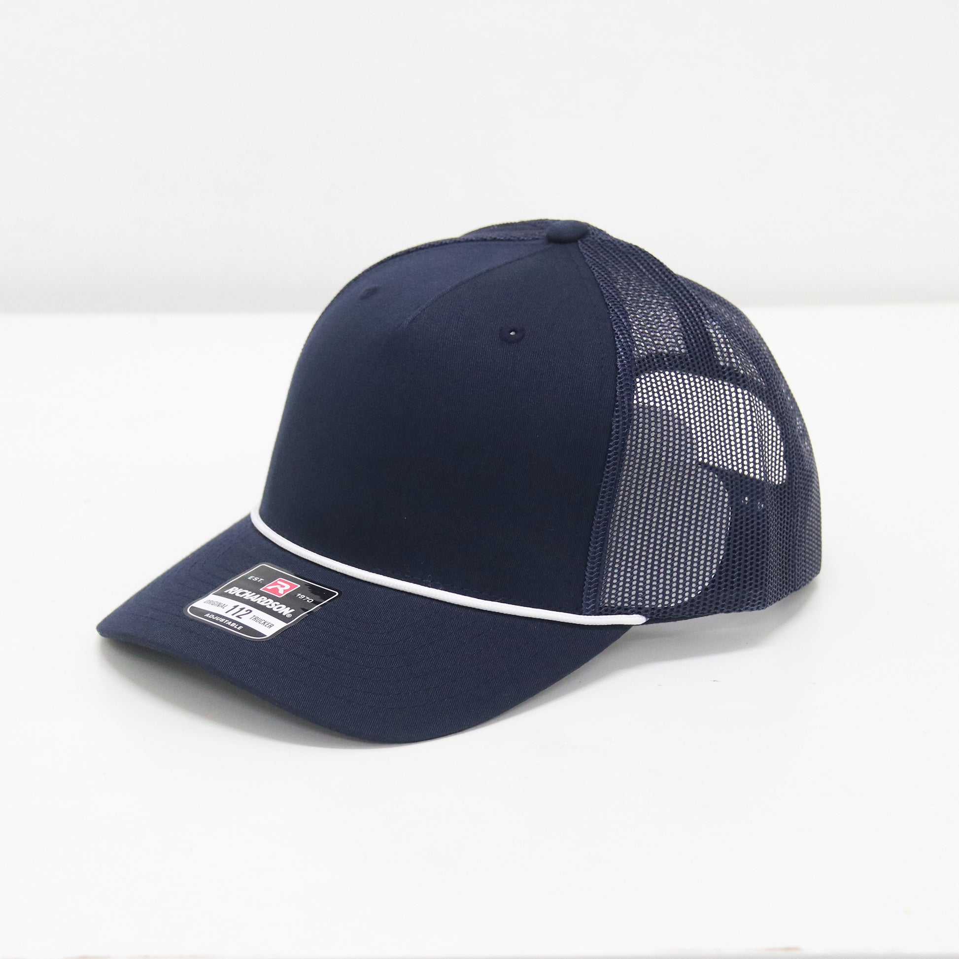 Navy blue cap with mesh back on a white background