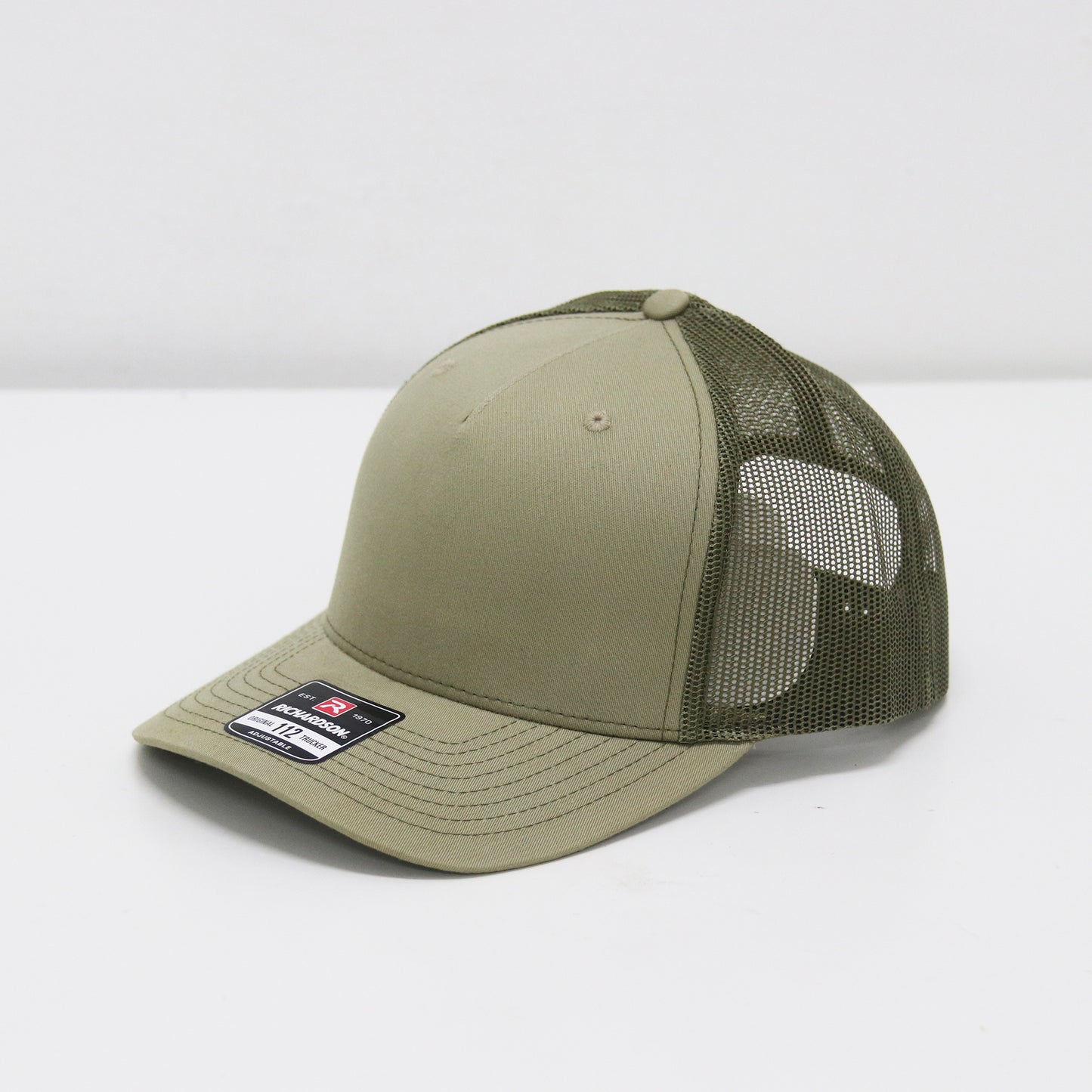 Green baseball cap with mesh back on a white background