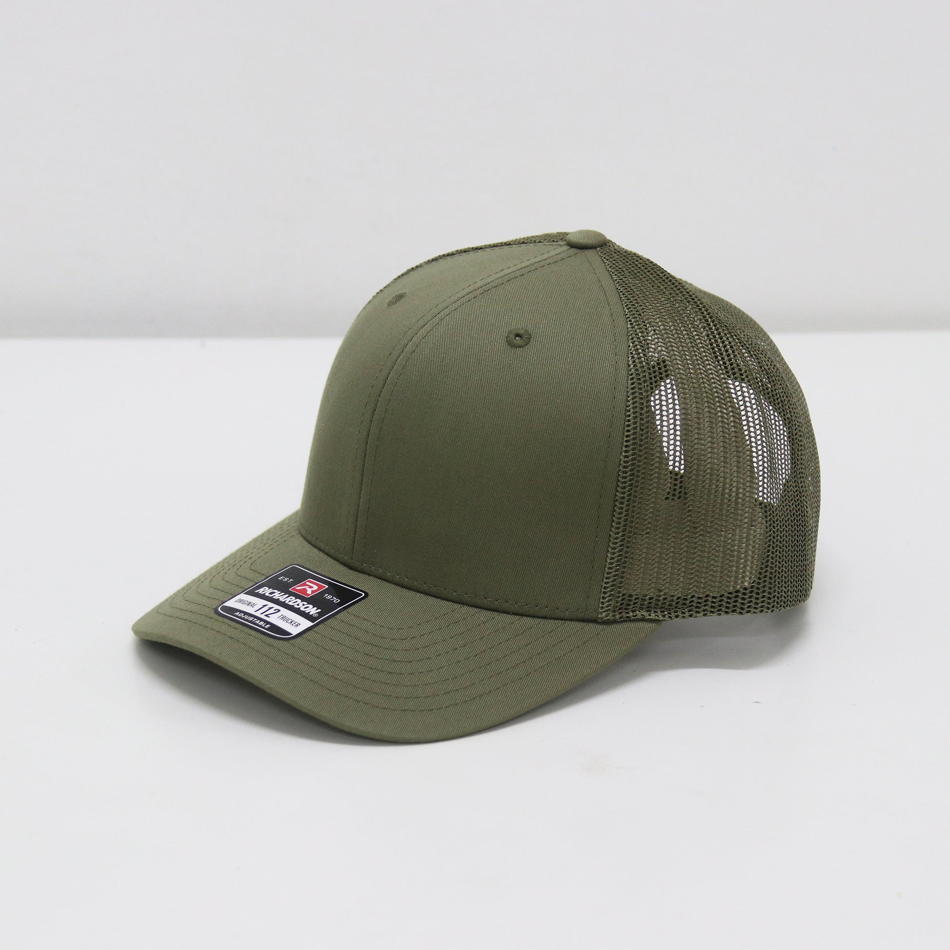 Green baseball cap with mesh back on a white background