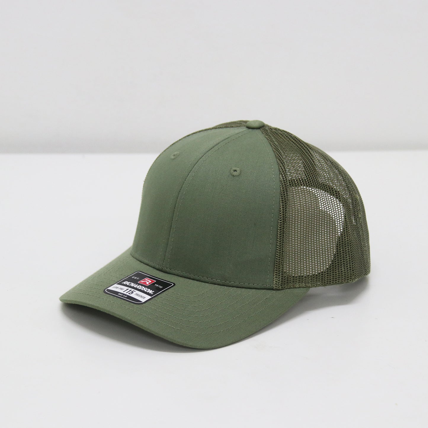 Green baseball cap with mesh back on a white background