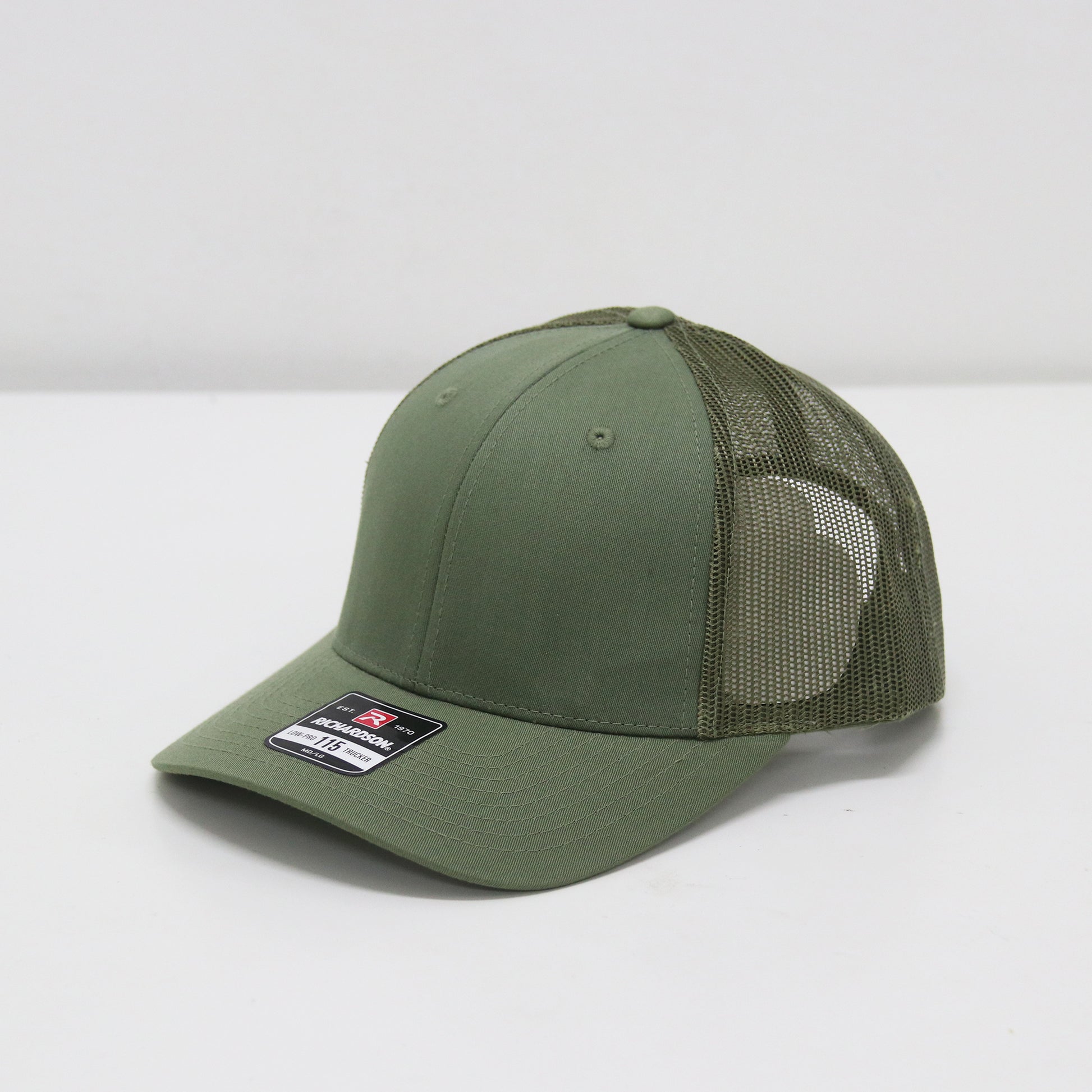 Green baseball cap with mesh back on a white background