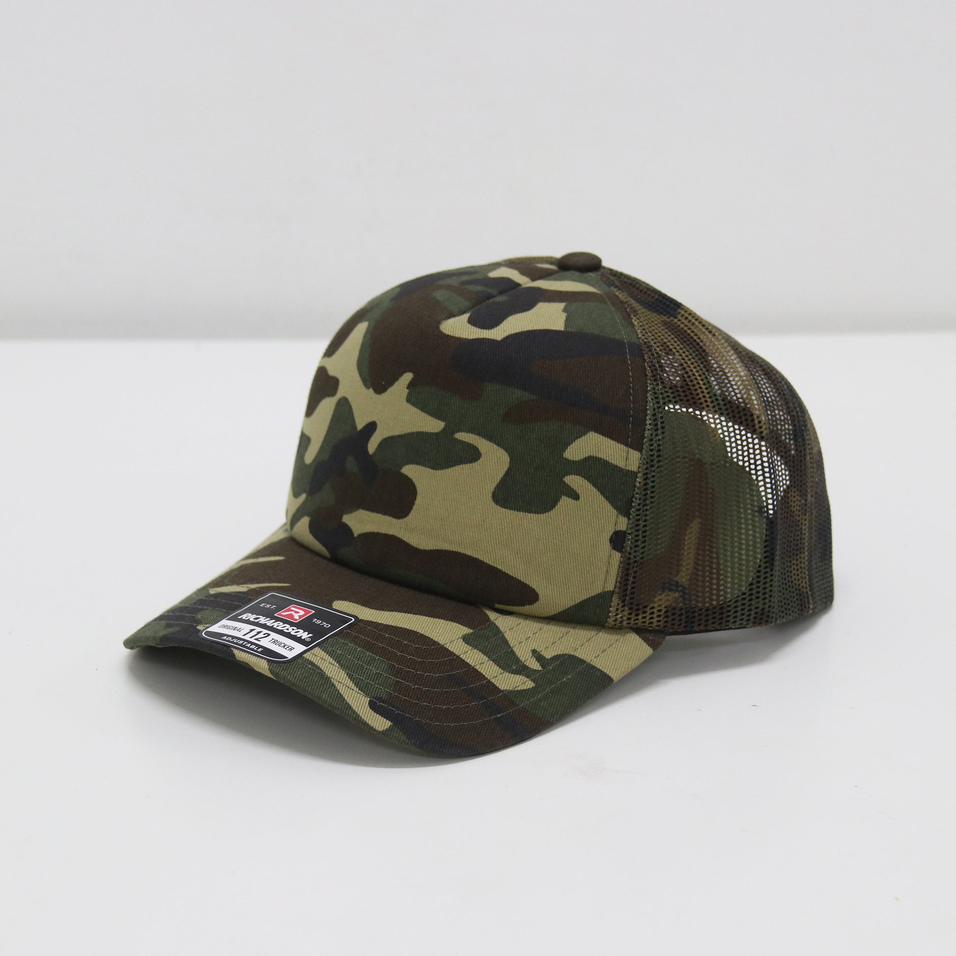 Camouflage baseball cap with mesh back on a white background