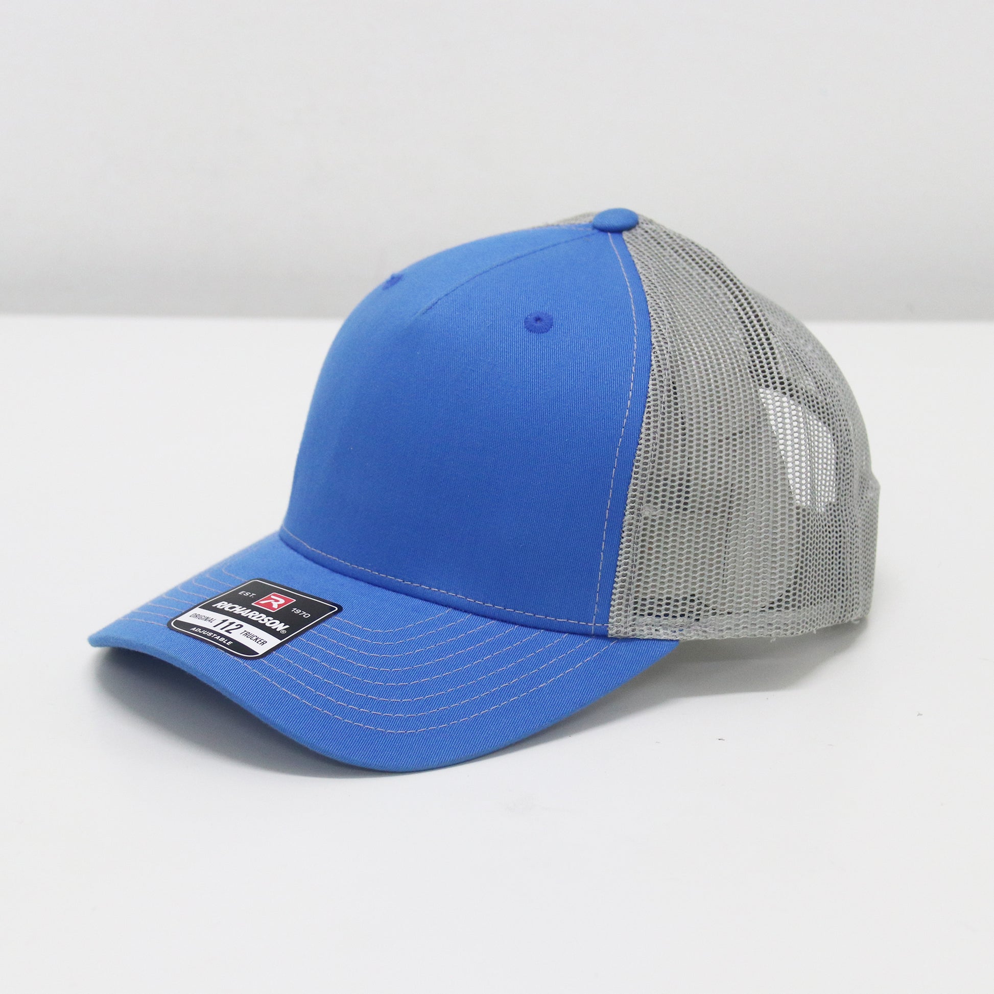Blue and gray cap with a brand label on a white background