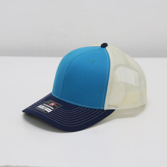 Blue and white cap with mesh back on a white surface