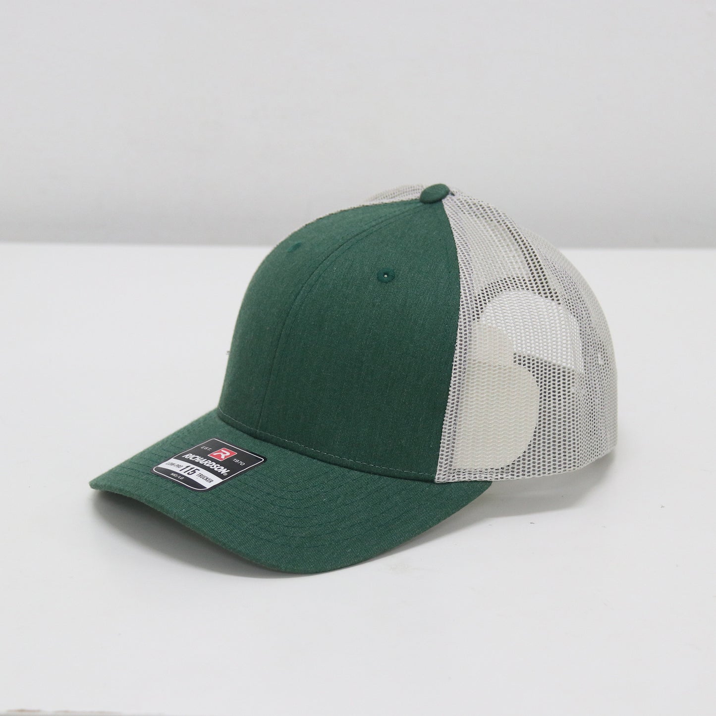 Green and white cap with mesh back on a white background
