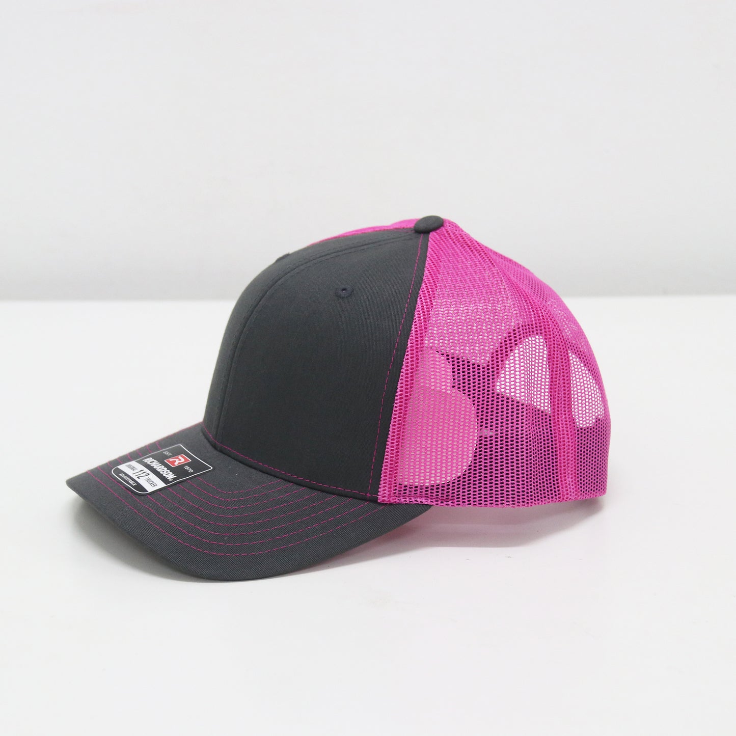 Black and pink mesh cap on a white background