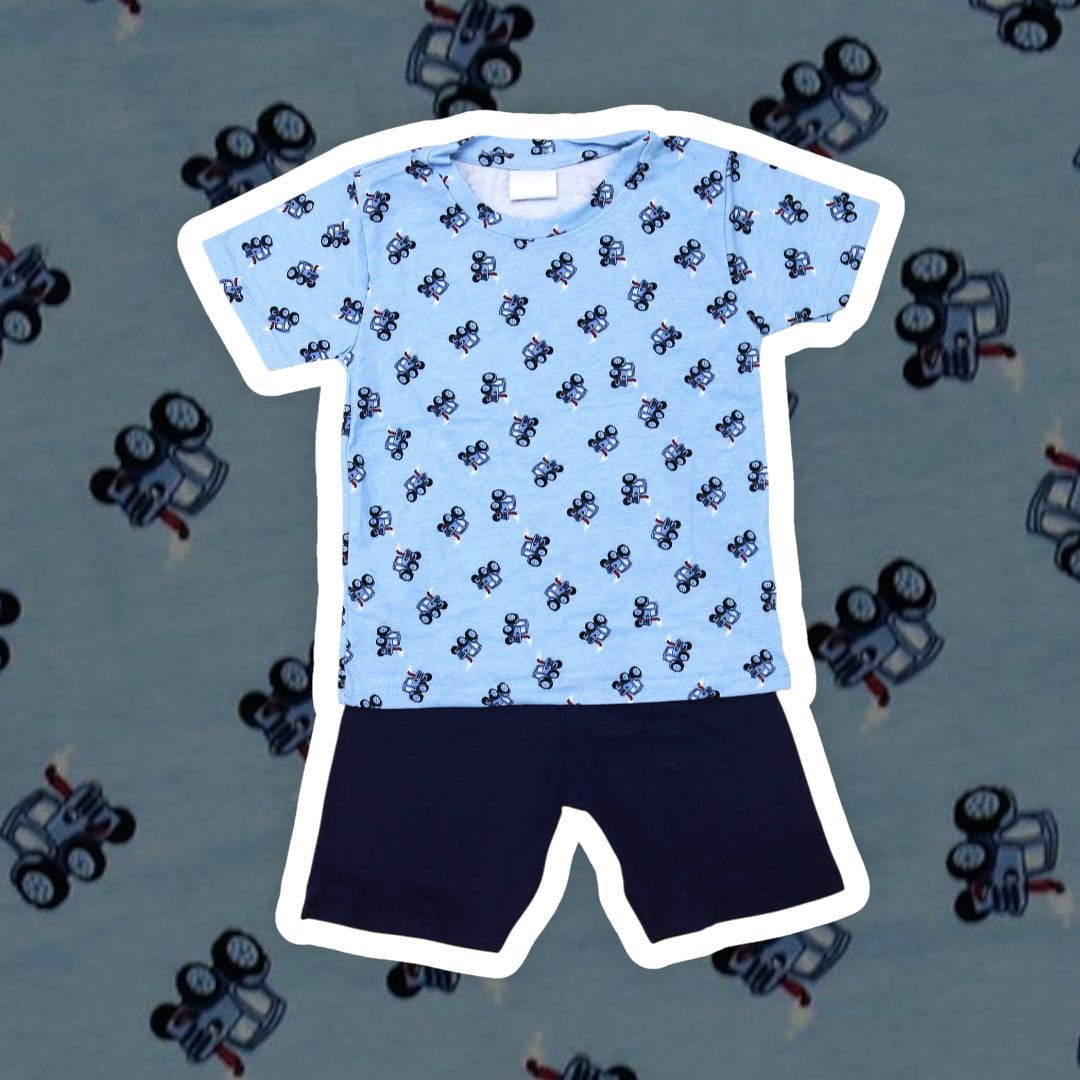 Children's blue shirt with black pattern and navy shorts on a light blue background with toy cars.