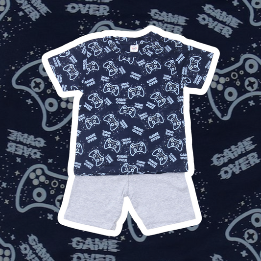 Children's outfit with blue t-shirt and gray shorts on a dark background with gaming-themed text.