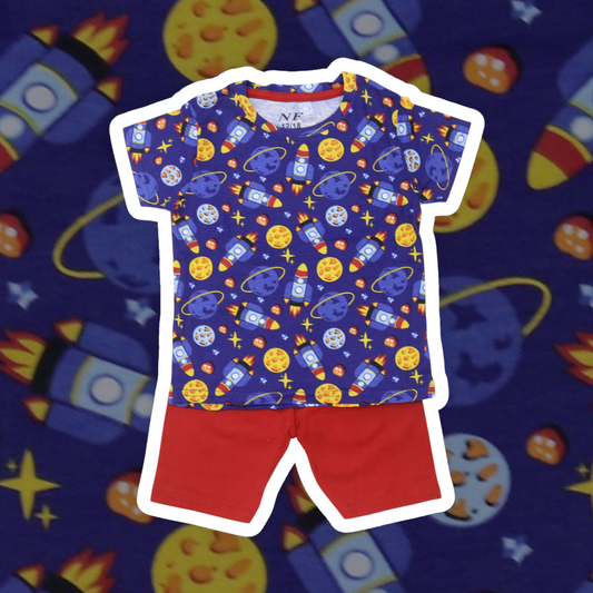 Children's outfit with space-themed shirt and red shorts on a colorful space-themed background