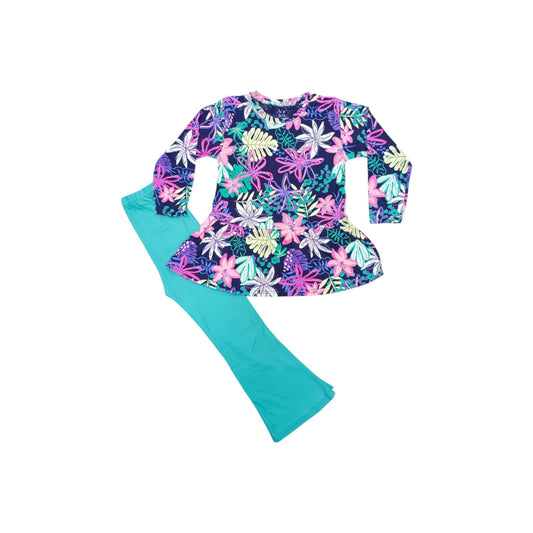 Colorful floral top and teal pants on a white background