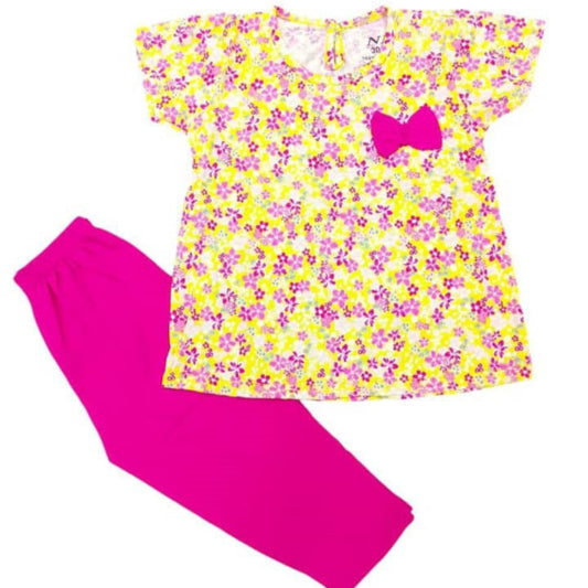 Yellow floral dress with pink bow and pink pants on a white background