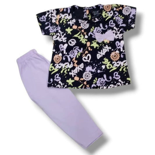 Children's outfit with a patterned top and lavender pants on a white background
