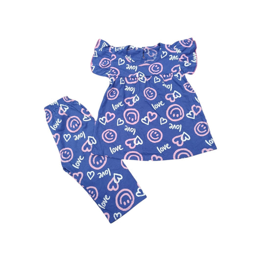 Children's outfit with blue patterned top and pants on a white background