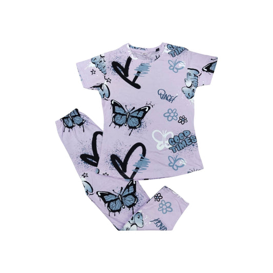 Children's pajama set with butterfly and heart designs on a light purple background.