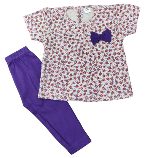 Floral top with a bow and purple pants on a white background
